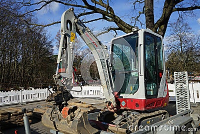 Mini excavator TAKEUCHI TB 216 at the construction site. Berlin, Germany Editorial Stock Photo