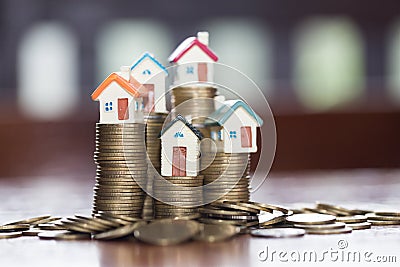 Mini house on stack of coins,Money and house, Real estate invest Stock Photo