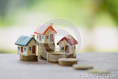 Mini house on stack of coins, Real estate investment, Save money Stock Photo