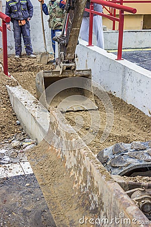 Mini Hydraulic Excavator arm and a bucket working Stock Photo