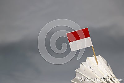 Mini Indonesia flag stick on the white shuttlecock on the grey background Stock Photo