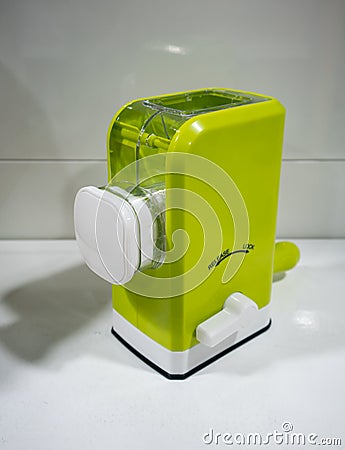 Mini kitchen tools for manual meat grinder with plastic container and green body Stock Photo