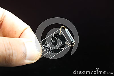 Mini magnetic reed switch module for minor project held in hand on black background, sensor for arduino, raspberry pi and other Stock Photo