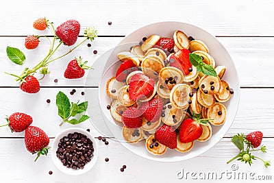 Mini pancakes with fresh strawberry and chocolate drops Stock Photo