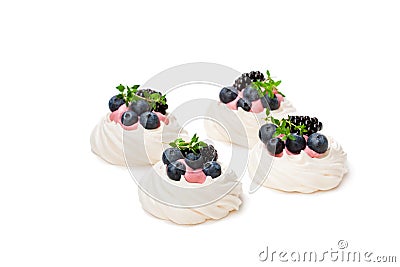 Mini Pavlova meringue nests with berries and thyme isolated on Stock Photo
