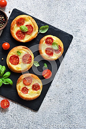 Mini pie with tomatoes and cheese. Quiche with vegetables and sauce top view Stock Photo