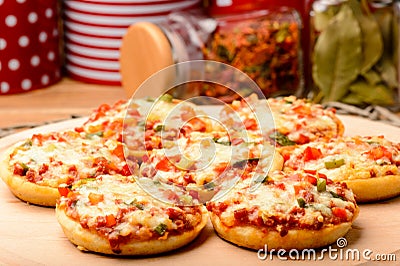 Mini pizzas on wooden board. Stock Photo