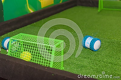 Mini Robot Scored a goal in a robot-controlled human match. Stock Photo