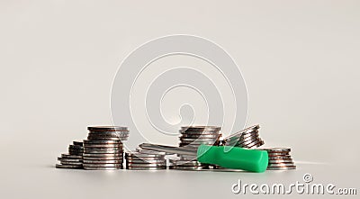 A mini screwdriver with a pile of coins. Stock Photo