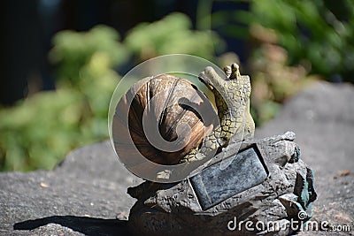 mini sculpture in a summer park crawling snail Stock Photo
