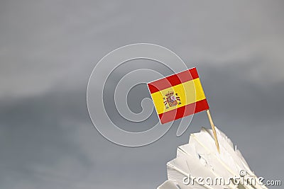 Mini Spain flag stick on the white shuttlecock on the grey background Stock Photo