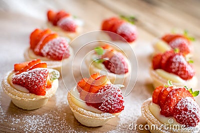 Mini strawberry tarts on wood background Stock Photo