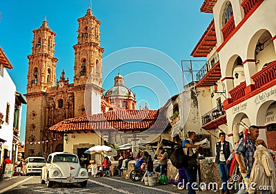 Mini taxi against the Cathedral of Taxco, Mexico. Editorial Stock Photo