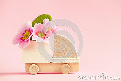 Mini toy wooden cargo truck model with beautiful fresh spring flowers Stock Photo