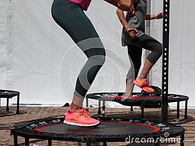 Mini Trampoline Workout: Girl doing Fitness Exercise in Class at Stock Photo