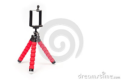 Mini tripod with flexible red legs and mobile phone holder Stock Photo