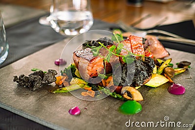 Mini tuna steaks with microgreens and potato side dish on a ceramic plate Stock Photo