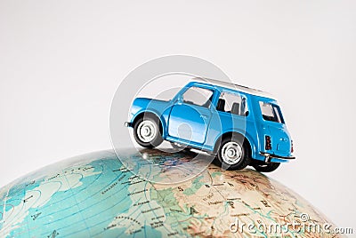 NIS, SERBIA - JANUARY 8 2018 Miniature figure toy car Mini Morris on geographical globe of earth on white background in studio Editorial Stock Photo