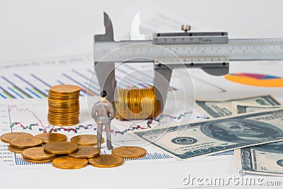 Miniature business man and vernier measuring money coin on business chart ,business Stock Photo