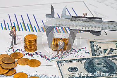 Miniature business man and vernier measuring coin Stock Photo