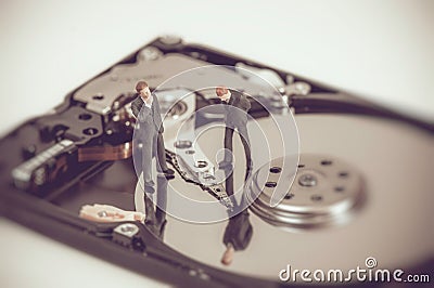 Miniature business people on top of hard drive. Business concept Stock Photo