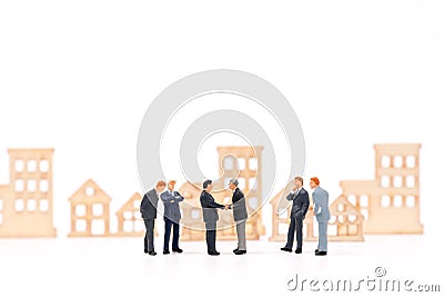 Miniature businessman dealing property and shaking hand Stock Photo