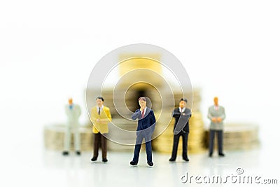 Miniature businessman and stack of coins. Image use for investment, saving money Stock Photo