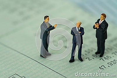 Miniature businessman standing on bank account book and others c Stock Photo