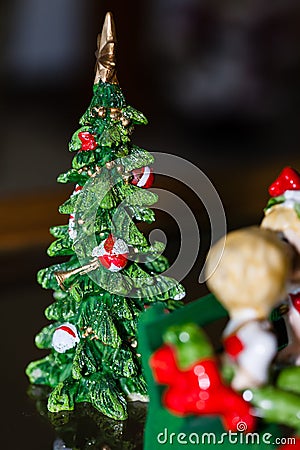 Miniature ceramic Christmas tree sitting on a table Stock Photo