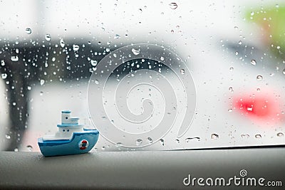 Miniature ceramic ship with rain water drops background Stock Photo