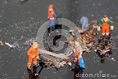 Miniature cleaners cleaning dust reflected Stock Photo