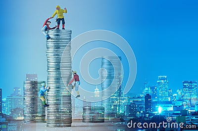 Miniature climbers team climbing on stack of coins Stock Photo