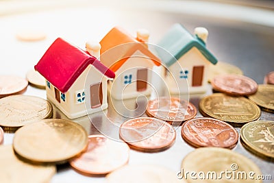 Miniature colorful house on stack coins Stock Photo