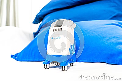 Miniature Coolsculpting machine model in a medspa clinic, on a patient bed in a branded room for Editorial Stock Photo