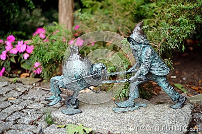 Miniature dwarf gnome in Botanical garden on Ostrow Tumski district of Wroclaw, Poland. Editorial Stock Photo