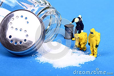 Miniature figure people inspecting salt spill Stock Photo