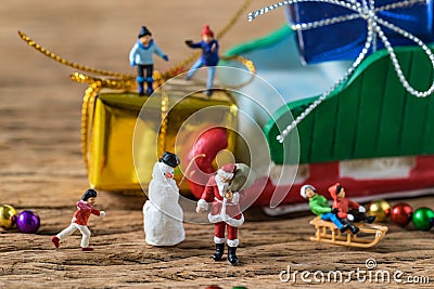 Miniature figure Santa claus with happy children running and sta Stock Photo