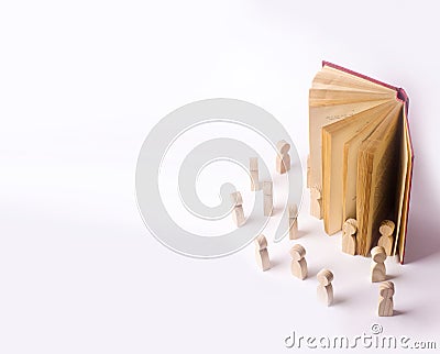 Miniature figures of people come out of the book into the real Stock Photo