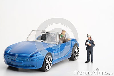 Miniature figurine of a policewoman making a fine to a car driver Stock Photo