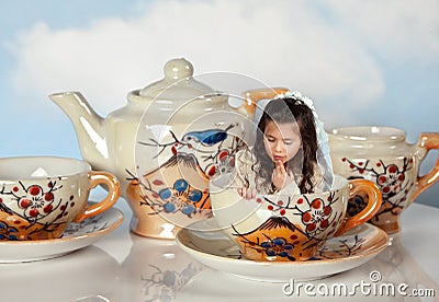 Miniature girl on tea party Stock Photo