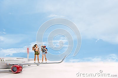Miniature Group hiker and traveler with backpack standing on the airplane blue sky background Stock Photo