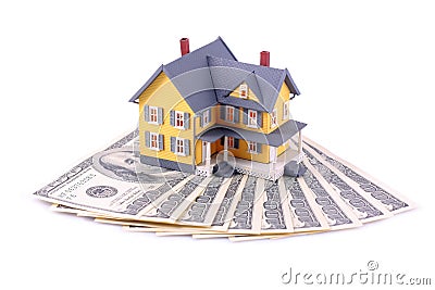 Miniature house over money isolated Stock Photo