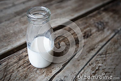 Miniature milk bottle with milk inside Stock Photo