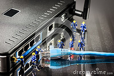 Miniature Network Engineers At Work. Technology concept Stock Photo