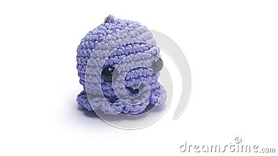 Miniature octopus keychain in purple colors crocheted on a white background Stock Photo