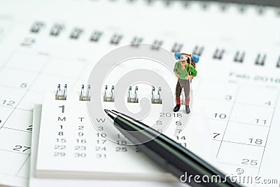 Miniature people, backpacker man figure standing on 2018 calendar with pen using as travel planning, vocation or holiday year plan Stock Photo