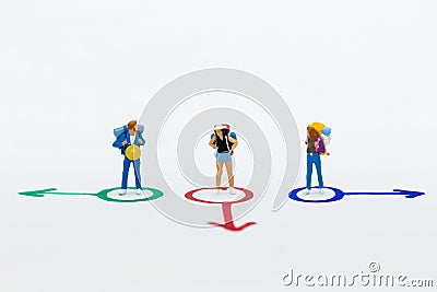 Miniature people : Backpacker walking follow arrow. Image use for travel, business concept Stock Photo