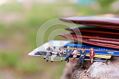 Miniature people : business people sitting on Credit card Stock Photo