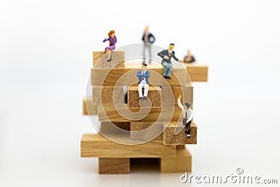 Miniature people: Business people sitting on puzzle pieces. Image use for find the answer of question, education , business Stock Photo