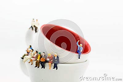 Miniature people : Business team sitting on cup of coffee and having a coffee break. Image use for business concept Stock Photo